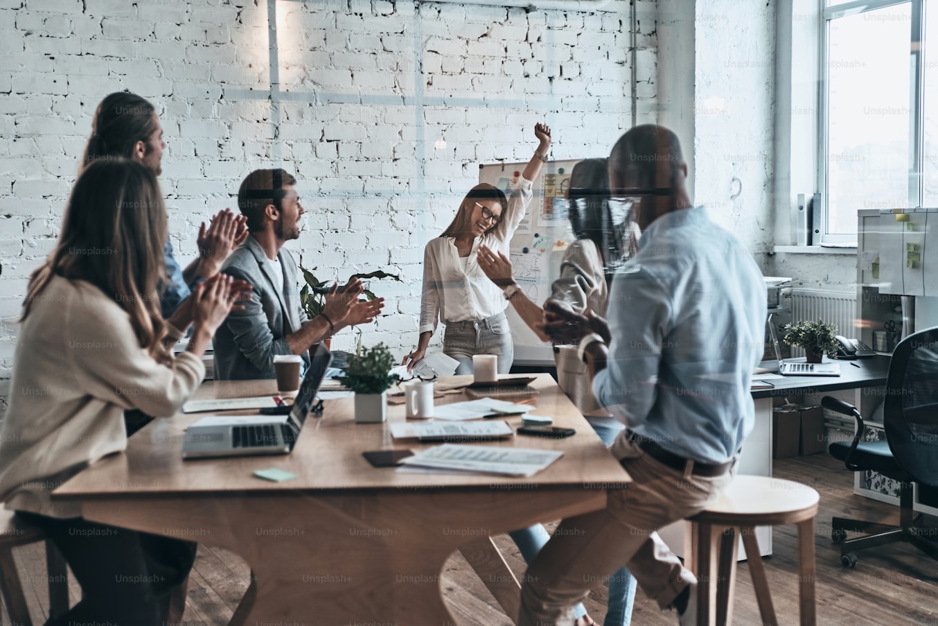 HR leaders shaking hands across a meeting table